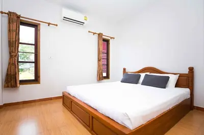 a bedroom with a white bed and a window at 