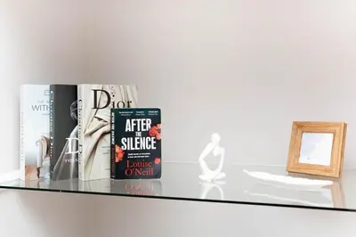 a shelf with books and a picture on it at 