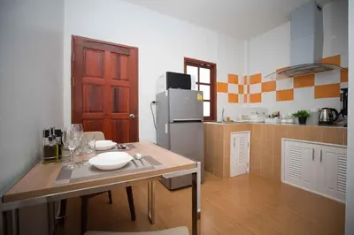 a kitchen with a table and a refrigerator at 