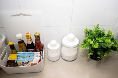 a kitchen counter with bottles and condiments and a plant at 