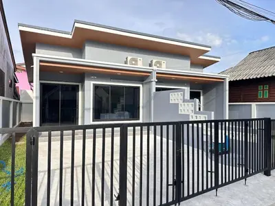 a house with a black fence in front of it at Layla house, Bang Tao beach in Ban Thalat Choeng Thale