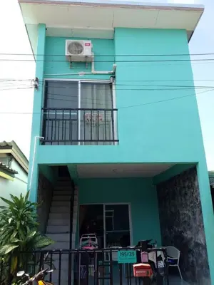 a blue house with a balcony and a table at MAM house in a quiet and stylish location in Ban Thalat Choeng Thale