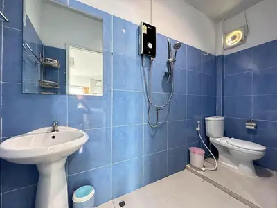 a blue tiled bathroom with a shower and a toilet at MAM house in a quiet and stylish location in Ban Thalat Choeng Thale