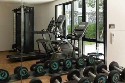 a gym with rows of exercise bikes in front of a window at Cozy Apartment at Rawai with Pool Access in Phuket Town