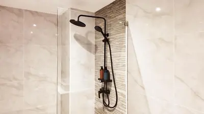 a shower with a shower head in a bathroom at Mali Villa 57 in Patong Beach