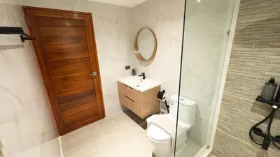 a bathroom with a toilet and a sink and a mirror at Mali Villa 57 in Patong Beach