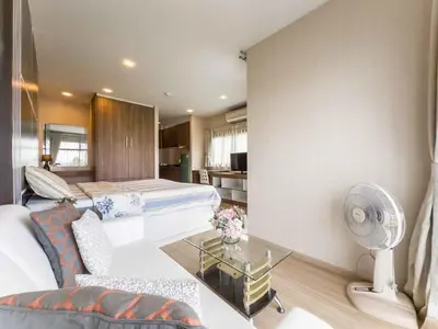 a bedroom with a bed and a living room at Apartments in the NICE condominium on Bang Tao Beach in Ban Thalat Choeng Thale