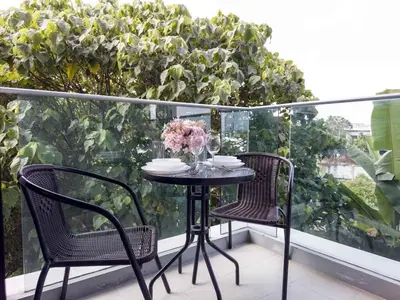a table and two chairs on a balcony at Apartments in the NICE condominium on Bang Tao Beach in Ban Thalat Choeng Thale