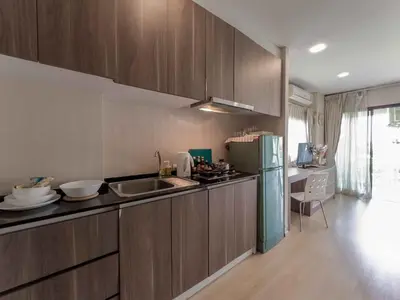 a kitchen with a sink and a refrigerator at Apartments in the NICE condominium on Bang Tao Beach in Ban Thalat Choeng Thale