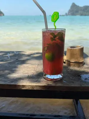 a drink sitting on a table next to the ocean at sunflower \u4e00\u5367\u7cbe\u54c1\u5927\u5e8a\u623f\u5e26\u9633\u53f0 in Patong Beach