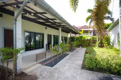 a patio of a house with a pergola at NI houses in Ban Thalat Choeng Thale
