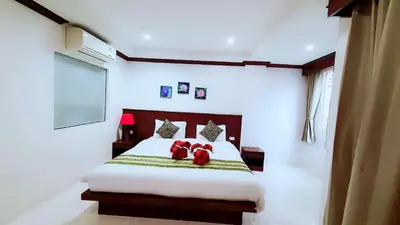 a bedroom with a bed with red pillows on it at fruit paradise hotel in Patong Beach