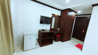a small room with a refrigerator and a television at fruit paradise hotel in Patong Beach
