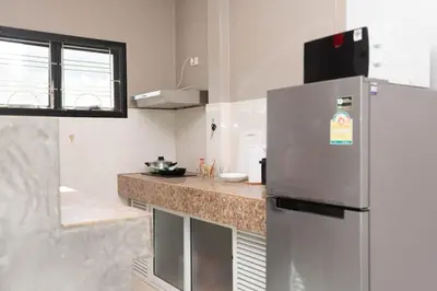 a kitchen with a refrigerator and a counter top at House in a quiet and stylish location NU8, Bang Tao in Surin Beach