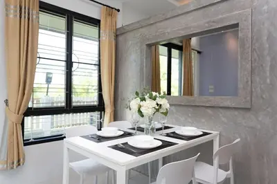 a white dining room table with white chairs and a mirror at House in a quiet and stylish location NU8, Bang Tao in Surin Beach
