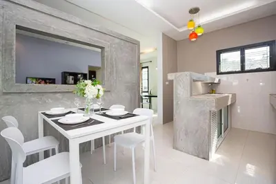a white dining room with a white table and chairs at House in a quiet and stylish location NU8, Bang Tao in Surin Beach