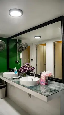 a bathroom with two sinks and a large mirror at The highdogs hostel in Phi Phi Don