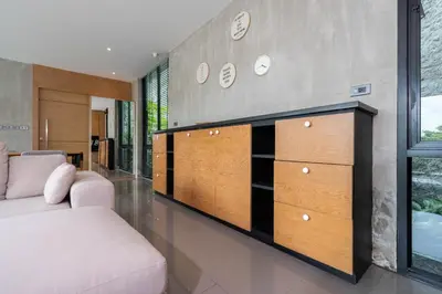 a living room with a couch and a dresser at Peaceful retreat at The Woods Natural Park in Kamala Beach