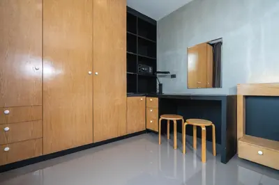 a kitchen with wooden cabinets and stools in it at Peaceful retreat at The Woods Natural Park in Kamala Beach