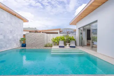 a swimming pool in the backyard of a house at The S Villas in Laguna Phuket