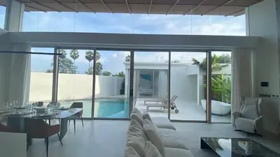 a living room with a couch and a table at 4bdr New Pool Villa Bangtao by Capital Pro ASH-37 in Ban Pak Lak