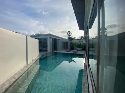 a house with a swimming pool next to a building at 4bdr New Pool Villa Bangtao by Capital Pro ASH-37 in Ban Pak Lak