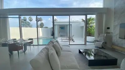 a living room with a white couch and a table at 4bdr New Pool Villa Bangtao by Capital Pro ASH-37 in Ban Pak Lak