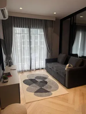 a living room with a couch and a rug at New and Stunning 1BR, The Title Legendary by UNO in Bang Tao Beach