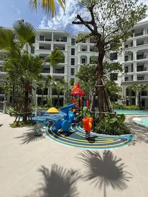 a playground in front of a large building at New and Stunning 1BR, The Title Legendary by UNO in Bang Tao Beach
