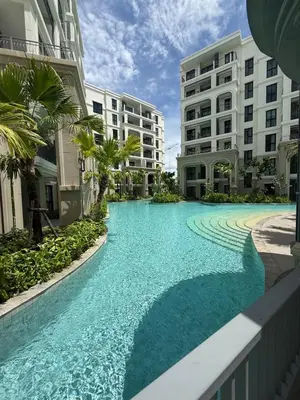a swimming pool in the middle of two buildings at New and Stunning 1BR, The Title Legendary by UNO in Bang Tao Beach