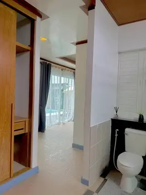 a bathroom with a toilet in a room at Suriyasom Villa 5 in Thalang