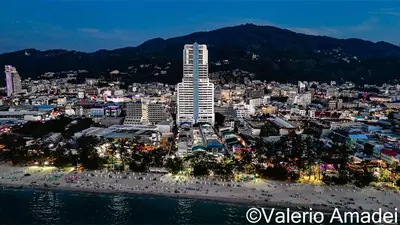 a view of a city at night with a beach at OMNIAPHUKET - Sea View Patong Tower - Top Location & Sea View in Patong Beach