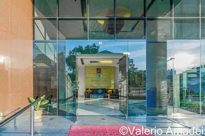 a reflection of a building in a glass wall at OMNIAPHUKET - Sea View Patong Tower - Top Location & Sea View in Patong Beach