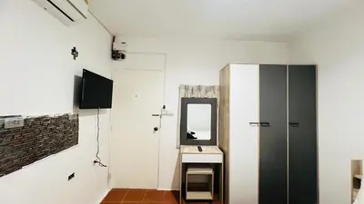 a bathroom with a mirror and a sink at Daisy House Patong in Patong Beach