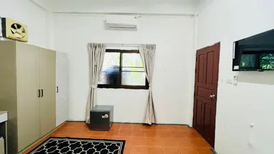 a living room with a door and a window at Daisy House Patong in Patong Beach