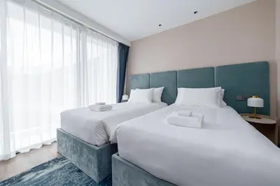 a bedroom with two beds and a large window at Laya Resort 1 bedroom By Ere in Layan Beach