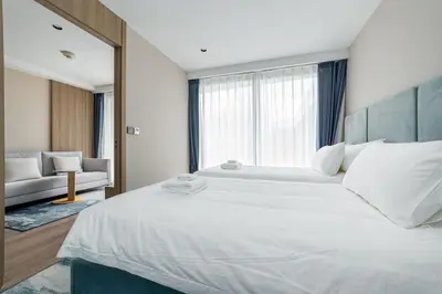 a bedroom with a large white bed and a couch at Laya Resort 1 bedroom By Ere in Layan Beach