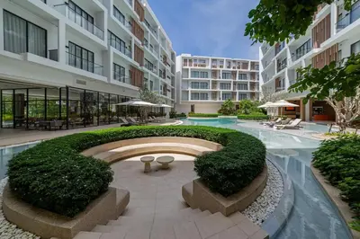 a courtyard of a building with a large building at Laya Resort 1 bedroom By Ere in Layan Beach
