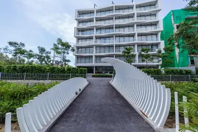 a bench in front of a building at Laya Resort 1 bedroom By Ere in Layan Beach