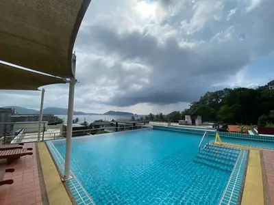 a large swimming pool on top of a building at The Bay cliff By Tris in Patong Beach