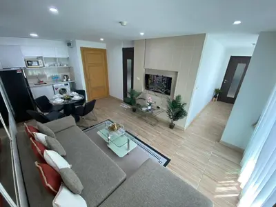 a living room with a couch and a fireplace at The Bay cliff By Tris in Patong Beach