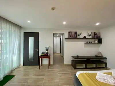 a bedroom with a bed and a table in a room at The Bay cliff By Tris in Patong Beach