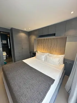 a bedroom with a large bed with a large headboard at CityGate Kamala 1 bedroom by Ere B312 in Kamala Beach