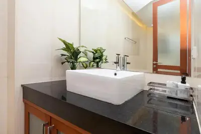 a bathroom with a white sink and a mirror at Tropical Dream Villa in Rawai Beach