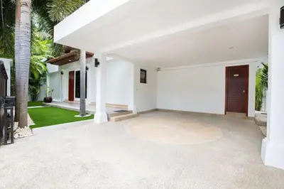 an empty courtyard of a house with palm trees at Tropical Dream Villa in Rawai Beach