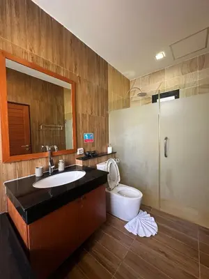 a bathroom with a sink and a toilet and a mirror at 3 bedroom Vip Villa Rawai Phuket in Rawai Beach