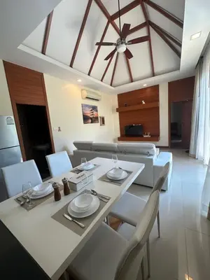 a dining room with a table and a ceiling fan at 3 bedroom Vip Villa Rawai Phuket in Rawai Beach