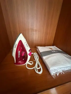 a red and white phone on a table next to a book at 3 bedroom Vip Villa Rawai Phuket in Rawai Beach