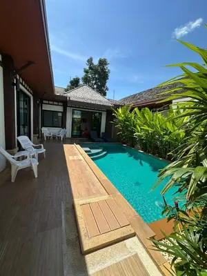 a swimming pool in the backyard of a house at 3 bedroom Vip Villa Rawai Phuket in Rawai Beach