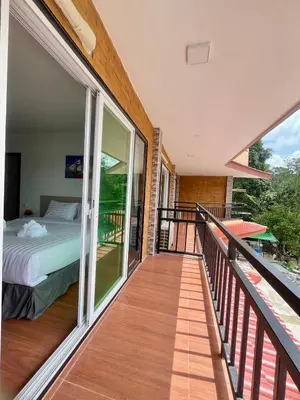a balcony with a bedroom and a bed on it at Lucky 9 Airport Hotel Phuket in Nai Yang Beach